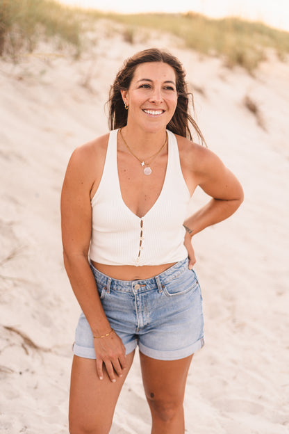 Model wearing the Kelsey necklace featuring a genuine freshwater pearl star charm on a classic gold chain crafted with waterproof 18k Gold PVD stainless steel.